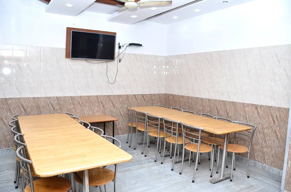 Spacious dining hall with seating and television at the girls hostel