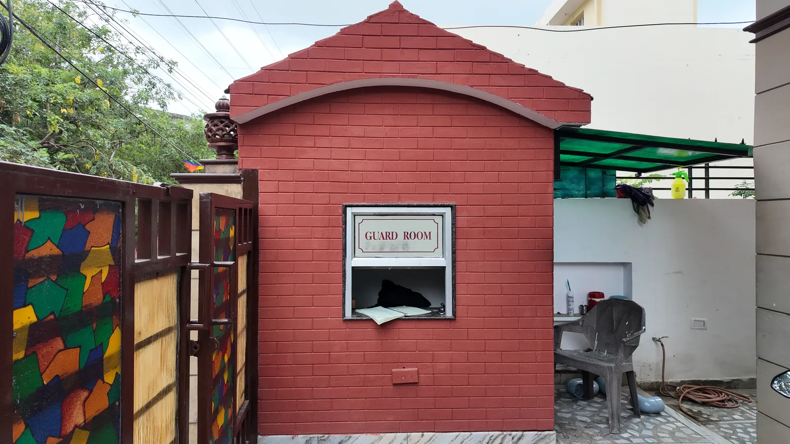 Gated entry and guard room at the hostel