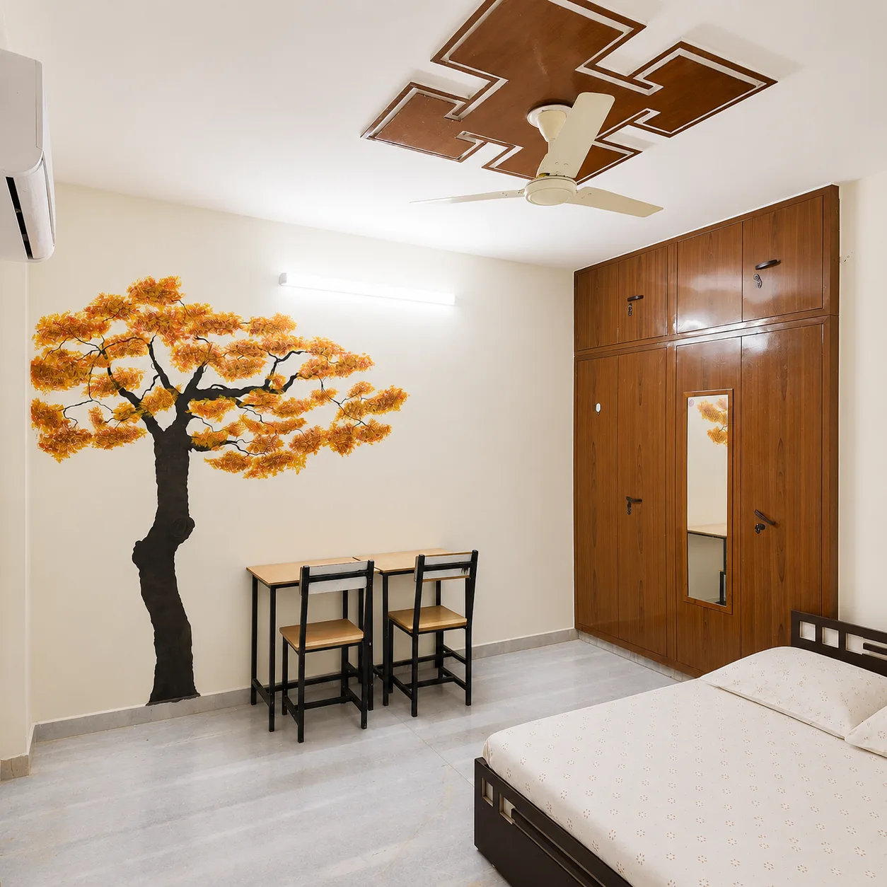 Furnished air-conditioned hostel room with wardrobe, mirror and study table